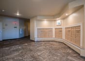 Thumbnail 7 of 8 - A hallway with a row of lockers on the right side.