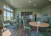 Thumbnail 2 of 8 - A dining room with a round table and chairs.