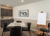 Thumbnail 48 of 52 - a dining room with a table and chairs and a white board on a easel