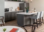Thumbnail 36 of 52 - an open kitchen and dining area with a table and chairs