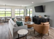 Thumbnail 9 of 52 - a living room with couches and chairs and a tv