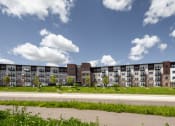 Thumbnail 18 of 52 - an exterior view of an apartment building on a sunny day