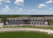 Thumbnail 15 of 52 - an aerial view of an apartment building overlooking a road and a field