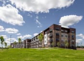 Thumbnail 22 of 52 - a large building with green grass in front of it