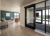 Thumbnail 13 of 52 - a living room with sliding glass doors and a table with chairs