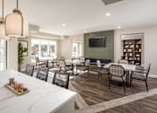 Thumbnail 11 of 19 - A modern dining room with a long table and chairs.