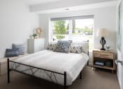 Thumbnail 3 of 25 - a bedroom with a bed and a window