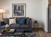 Thumbnail 23 of 25 - a living room with a gray couch and a coffee table