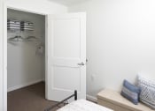 Thumbnail 15 of 25 - a bedroom with a closet and a bed and a white door
