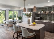 Thumbnail 13 of 25 - a kitchen with a large island and a table with chairs