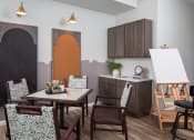 Thumbnail 14 of 25 - a dining room with a table and chairs and a kitchen with a chalkboard wall