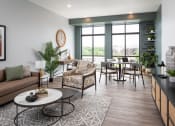 Thumbnail 7 of 25 - a living room with a couch and a table in front of a window