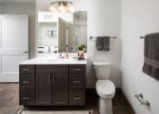 Thumbnail 19 of 25 - a bathroom with a toilet and a sink and a mirror