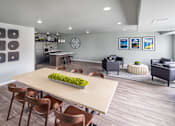 Thumbnail 8 of 11 - A modern dining room with a long table and chairs.