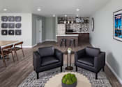 Thumbnail 5 of 11 - Two black leather chairs are placed in a room with a green plant on the table between them.