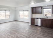 Thumbnail 3 of 11 - A kitchen with wooden floors and a stainless steel dishwasher.