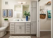 Thumbnail 19 of 24 - A bathroom with a white toilet, a white sink, and a white cabinet.