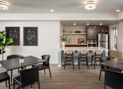 Thumbnail 24 of 24 - A modern kitchen with a dining table and chairs.