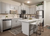 Thumbnail 3 of 24 - A kitchen with white cabinets and a white island with two chairs.