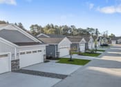 Thumbnail 3 of 43 - a row of houses with cars parked in front of them