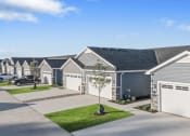 Thumbnail 4 of 43 - a row of gray and white houses in a neighborhood