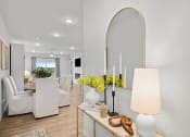 Thumbnail 22 of 43 - a living room with white furniture and a large mirror
