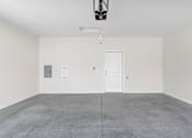 Thumbnail 13 of 25 - A white door is on the right side of the room.