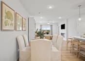 Thumbnail 20 of 43 - a dining room with a table and chairs