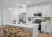 Thumbnail 19 of 43 - a kitchen with white cabinets and a white counter top
