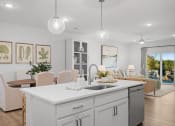 Thumbnail 11 of 43 - an open concept kitchen and living room with an island and a dining table