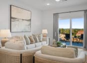 Thumbnail 6 of 43 - a living room with a couch and chairs and a sliding glass door