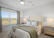 Thumbnail 13 of 43 - a bedroom with a bed and a ceiling fan