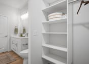 Thumbnail 21 of 43 - a bathroom with white shelves and a toilet and a sink