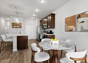 Thumbnail 16 of 62 - A modern kitchen with a dining table set for two.