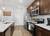 Thumbnail 20 of 62 - A kitchen with a white counter top and a sign that says Bon Appetit.