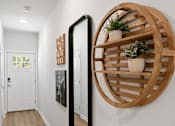 Thumbnail 21 of 62 - A white door is on the left and a wooden shelf is on the right.