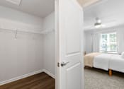 Thumbnail 33 of 62 - A white bedroom with a bed and a window.