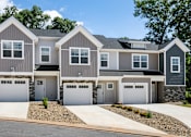 Thumbnail 40 of 62 - A row of houses with garages in front.