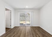 Thumbnail 45 of 62 - A room with a white door and a window with a view of a stone wall.