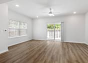 Thumbnail 52 of 62 - A room with wooden flooring and a ceiling fan.
