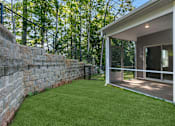 Thumbnail 7 of 62 - A house with a stone wall and a glass door.