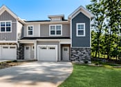 Thumbnail 1 of 62 - A modern two-story house with a garage.