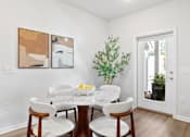 Thumbnail 17 of 62 - A dining room with a white table and chairs.