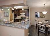 Thumbnail 12 of 49 - A kitchen with a dining table set for two.