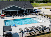 Thumbnail 15 of 29 - A pool with a black fence and a black and white striped poolside.