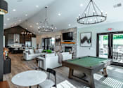 Thumbnail 19 of 29 - A well-lit, spacious living room with a pool table and comfortable seating.