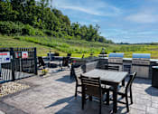 Thumbnail 20 of 29 - A patio with a table and chairs is surrounded by a fence with a sign that reads "Dangerous Property".