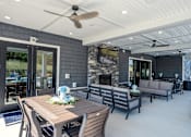 Thumbnail 25 of 29 - A modern outdoor dining area with a wooden table and chairs.