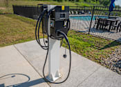 Thumbnail 24 of 29 - A charging station for electric vehicles is located on a concrete pad.