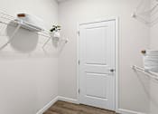 Thumbnail 19 of 39 - A white door is in the middle of a room with a shelf above it.